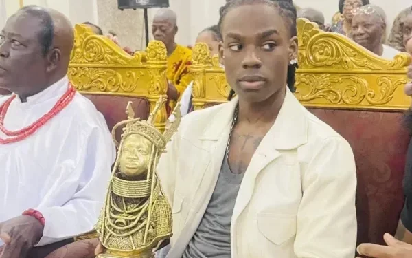 Rema receives a Royal plaque from the Oba of Benin.